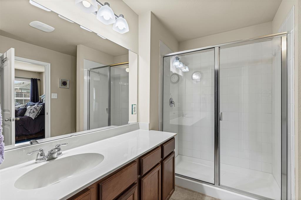 1104 Ruby Court Princeton, TX 75407 - Photo 32 of 40 a bathroom with a sink shower and a mirror