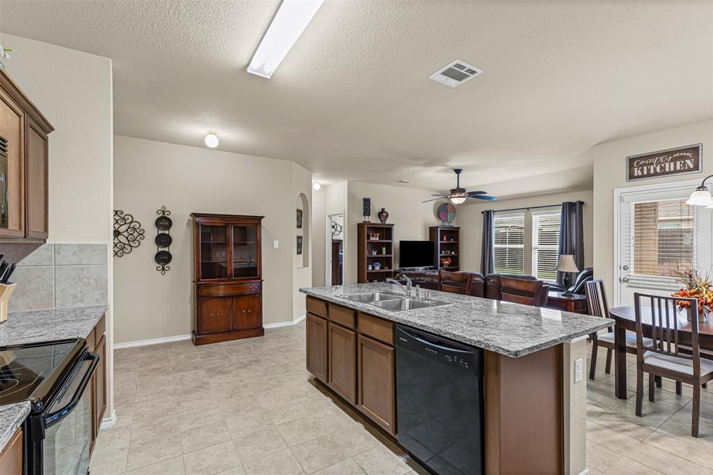 1104 Ruby Court Princeton, TX 75407 - Photo 40 of 40 a kitchen with stainless steel appliances granite countertop a stove and a refrigerator