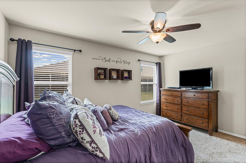 1104 Ruby Court Princeton, TX 75407 - Photo 8 of 40 a bedroom with a bed and a flat screen tv