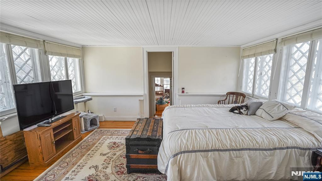 695 Ramapo Valley Road Oakland, NJ 07436 - Photo 24 of 42 a bedroom with a bed and flat screen tv