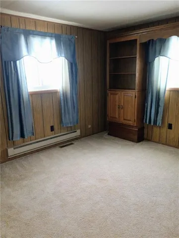 a view of an empty room with a cabinet