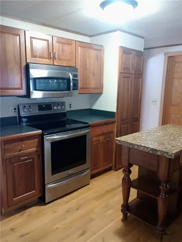 a kitchen with a stove and a microwave