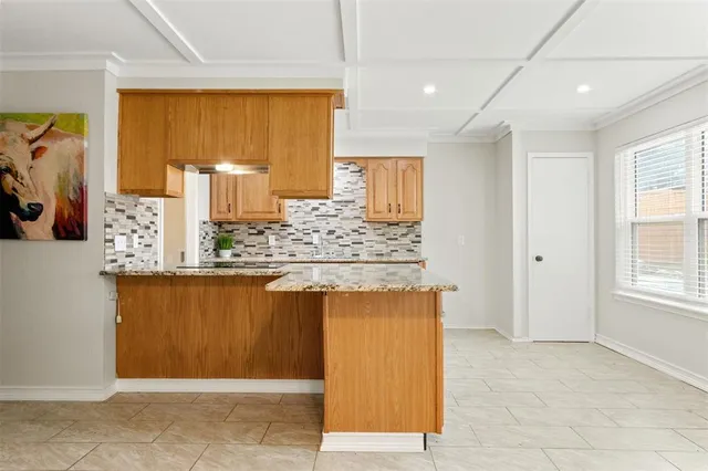 a kitchen with stainless steel appliances granite countertop a sink and a refrigerator