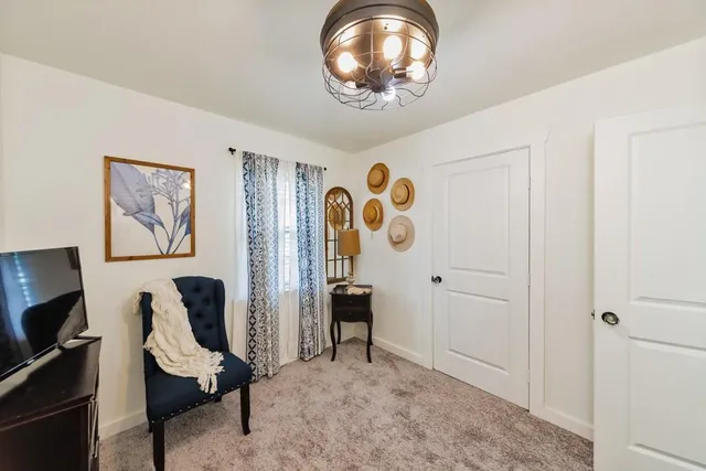 a view of a workspace with furniture and a window