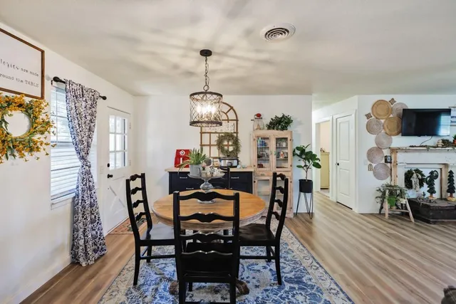 a view of a dining room with furniture window and wooden floor