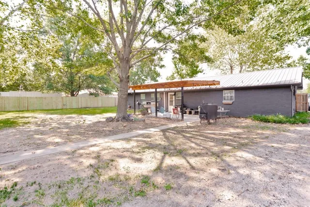 a front view of a house with a yard and a garden