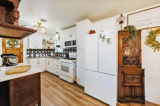 a kitchen with stainless steel appliances a refrigerator sink and stove