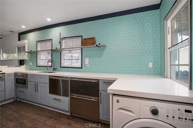 a stove top oven sitting inside of a kitchen