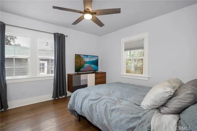 a bedroom with a bed a window and a chandelier