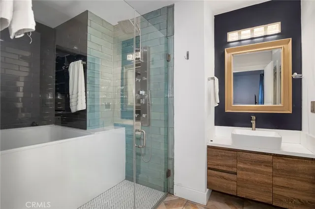 a bathroom with a tub sink and mirror