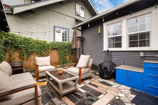 a backyard of a house with table and chairs