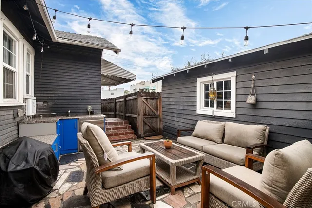 a balcony with furniture and a ceiling fan