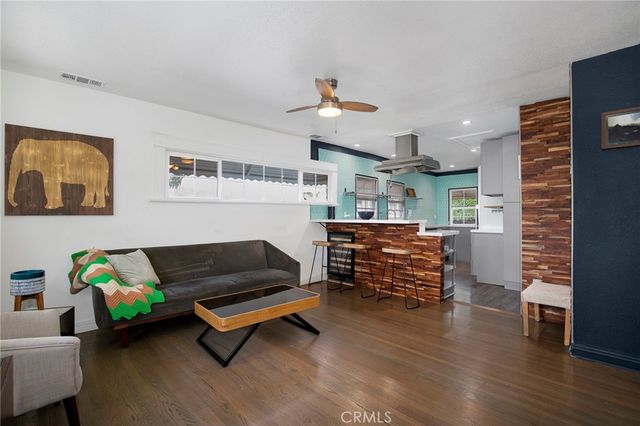 a bedroom with furniture and wooden floor