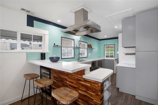 a room with furniture a large window and wooden floor