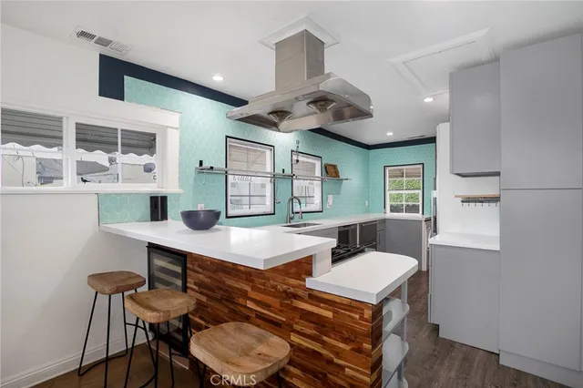 a room with furniture a large window and wooden floor