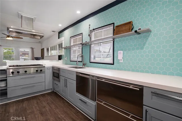 a kitchen with stainless steel appliances white cabinets and a stove