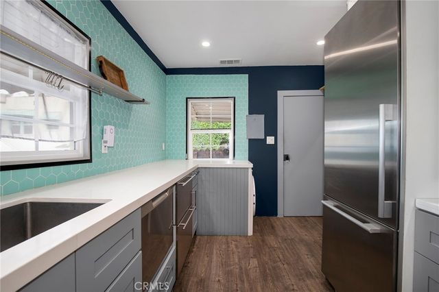 a kitchen with a refrigerator and a sink