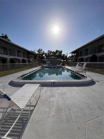 a view of roof deck with wooden floor and seating space