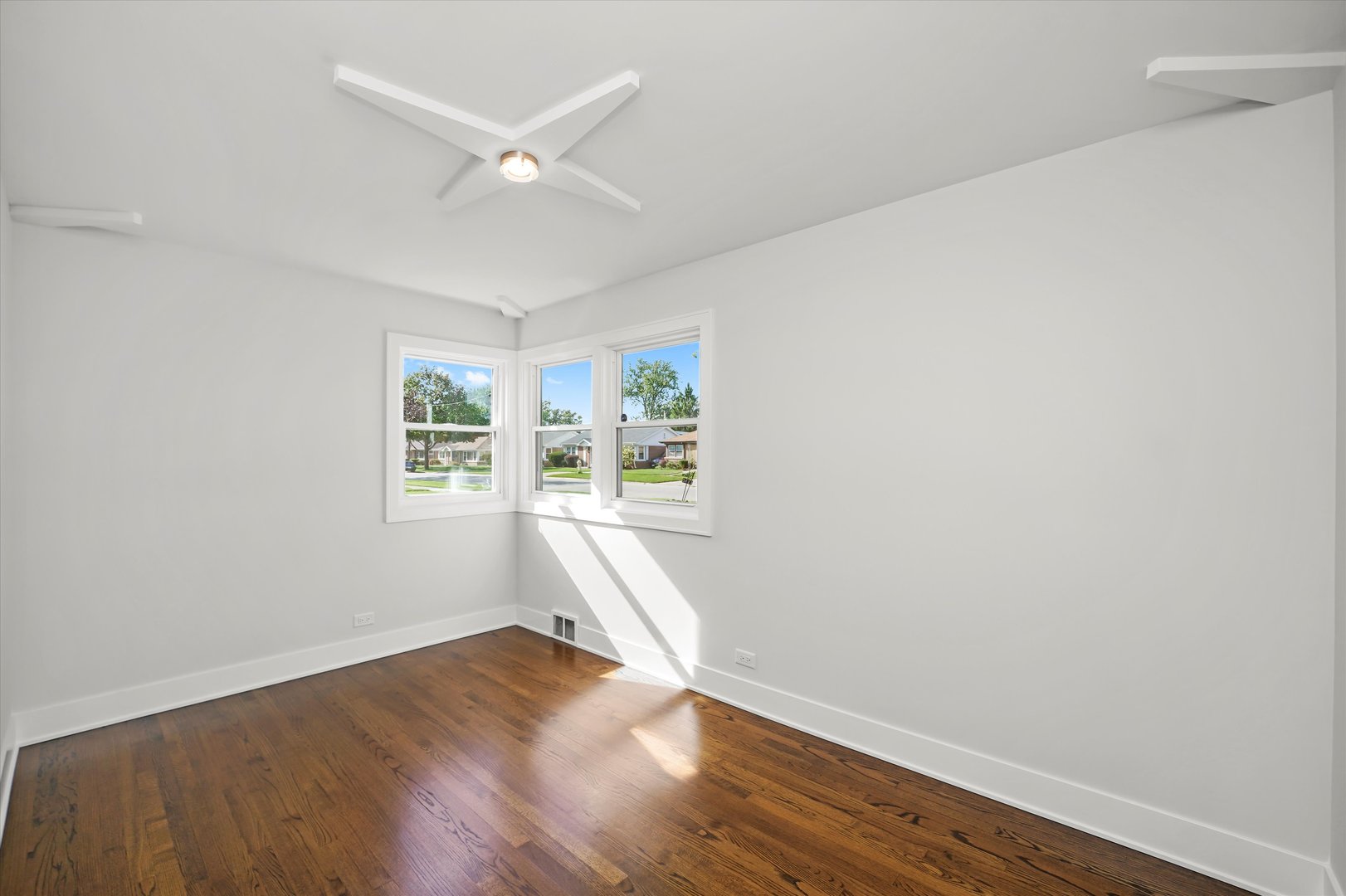 5809 Huron Street Berkeley, IL 60163 - Photo 15 of 26 an empty room with wooden floor and windows