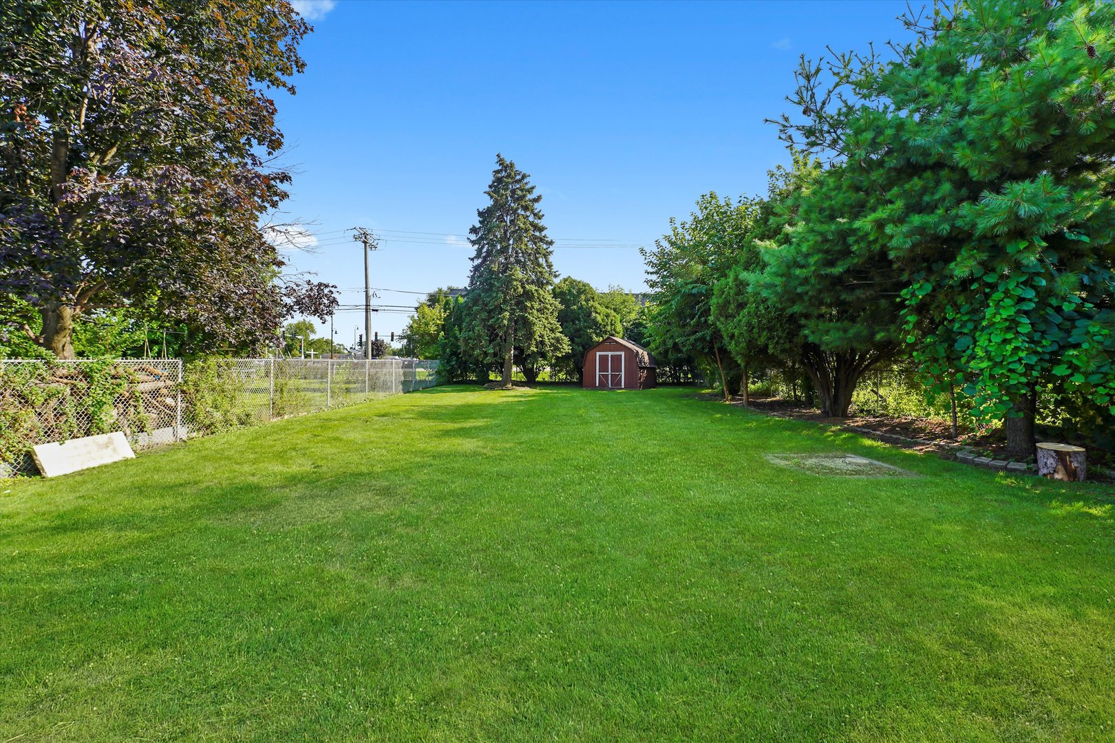 5809 Huron Street Berkeley, IL 60163 - Photo 18 of 26 a view of a field of grass and trees