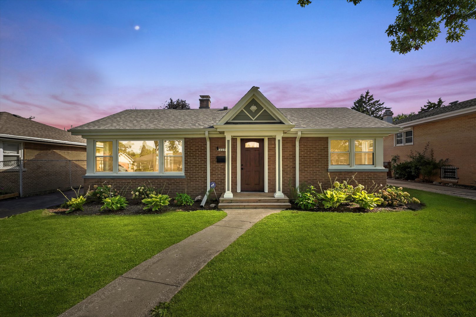 5809 Huron Street Berkeley, IL 60163 - Photo 2 of 26 a front view of a house with a yard table and chairs