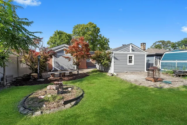 a front view of a house with a yard fire pit and outdoor seating