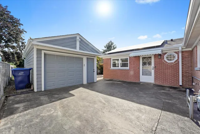 a front view of a house with a garden and yard