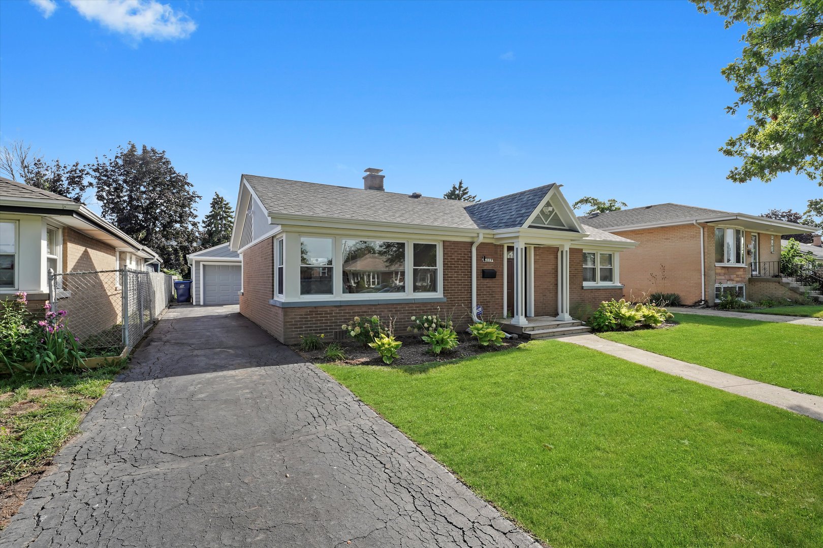 5809 Huron Street Berkeley, IL 60163 - Photo 24 of 26 a front view of a house with a garden and yard