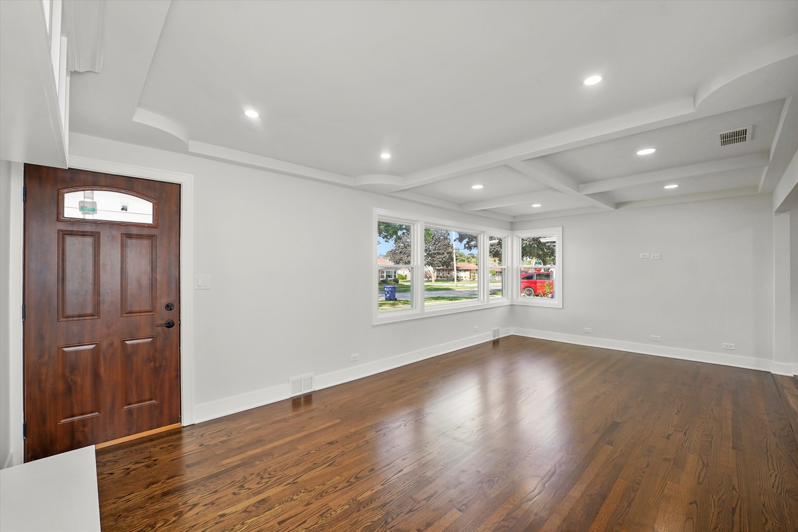 5809 Huron Street Berkeley, IL 60163 - Photo 3 of 26 an empty room with wooden floor and windows