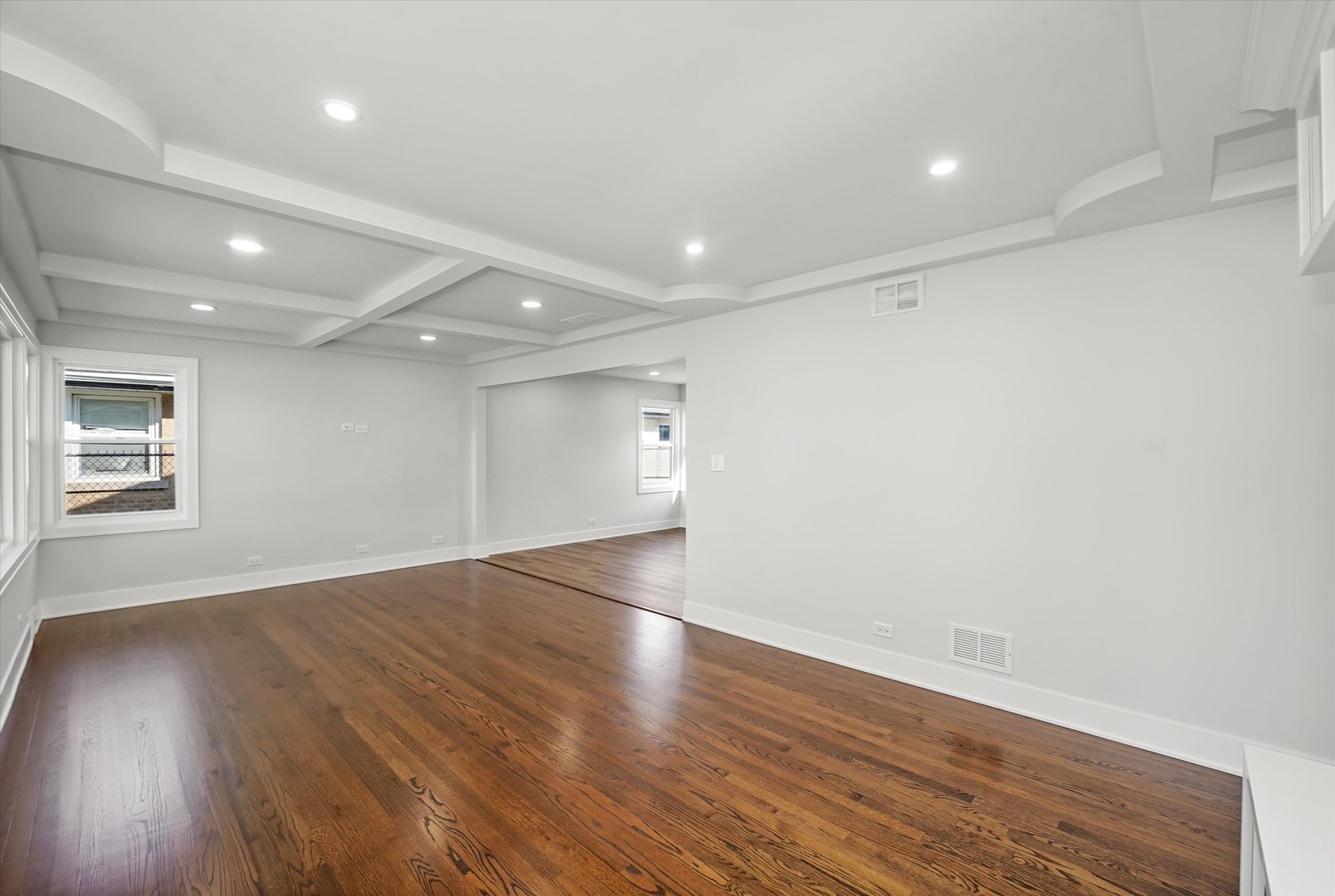 5809 Huron Street Berkeley, IL 60163 - Photo 5 of 26 an empty room with wooden floor and windows