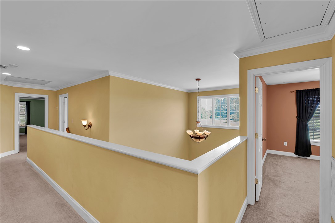 406 Hopewell Ridge Anderson, SC 29621 - Photo 17 of 46 This interior hallway features a graceful chandelier, carpeted flooring, and inviting natural light.