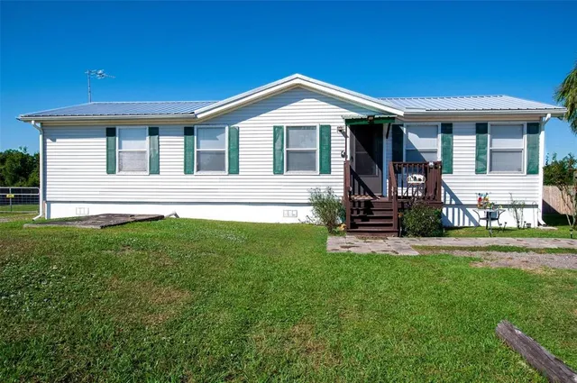a front view of house with yard and outdoor seating