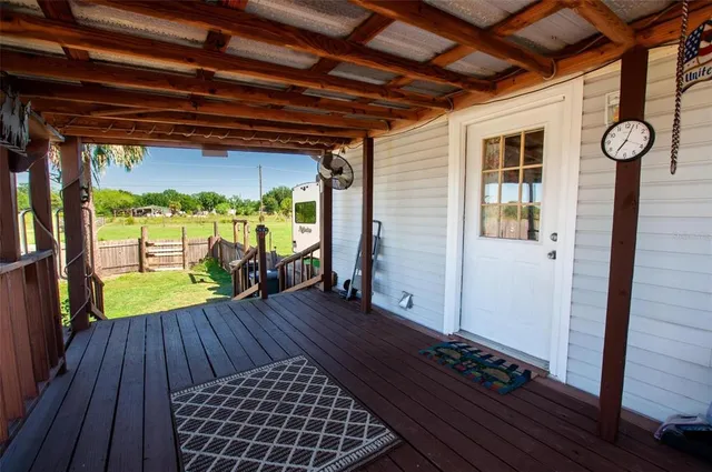 a view of porch with wooden floor