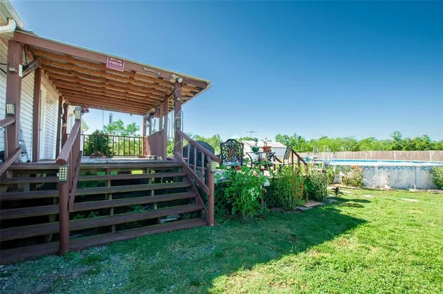 a view of a backyard with plants and a patio