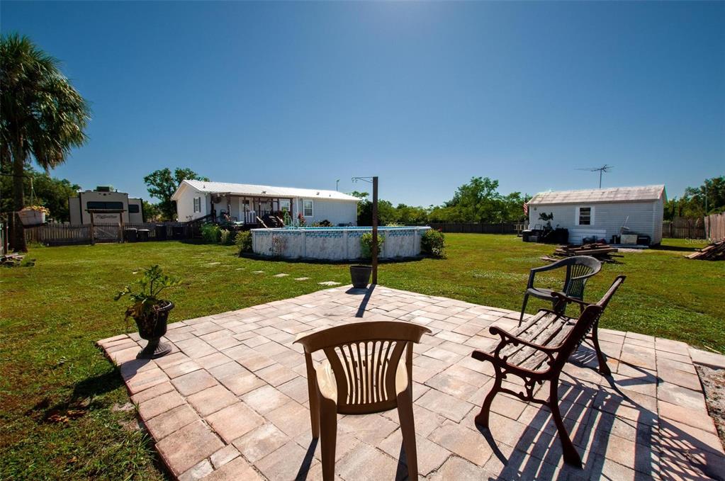 1317 Southwest Martha Street Arcadia, FL 34266 - Photo 18 of 25 a swimming pool with barbeque oven table and chairs