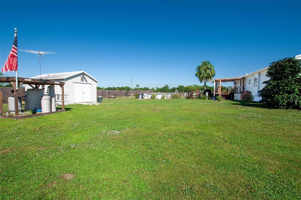 1317 Southwest Martha Street Arcadia, FL 34266 - Photo 19 of 25 a view of a house with a big yard and palm trees
