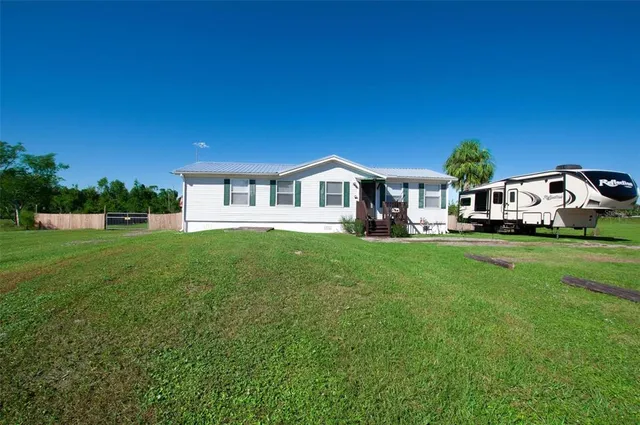 a front view of a house with a garden and yard
