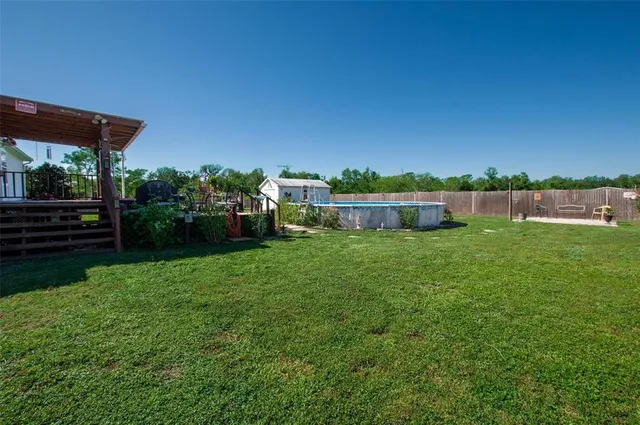 a view of a house with backyard and a hammock