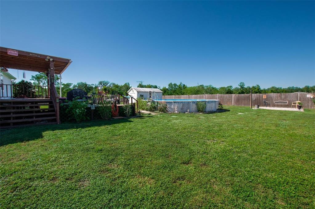 1317 Southwest Martha Street Arcadia, FL 34266 - Photo 21 of 25 a view of a house with backyard and a hammock