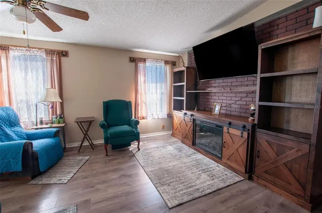 a living room with furniture a flat screen tv and a fireplace