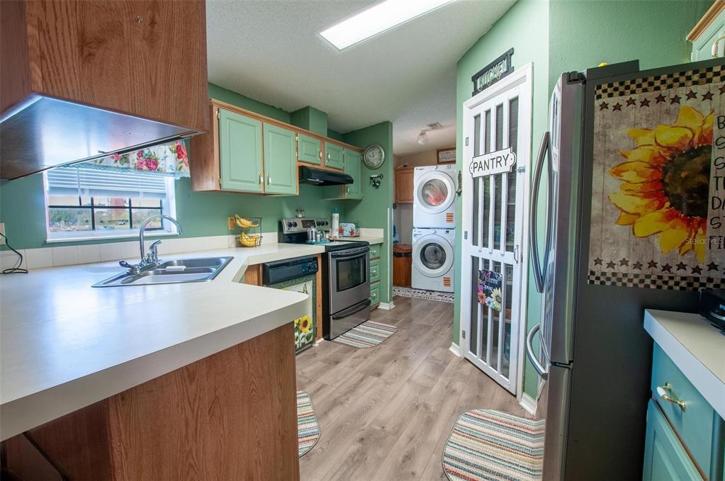 1317 Southwest Martha Street Arcadia, FL 34266 - Photo 7 of 25 a kitchen that has a lot of cabinets a sink and a stove in it