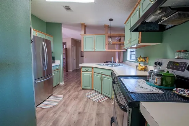a kitchen with a refrigerator and a sink