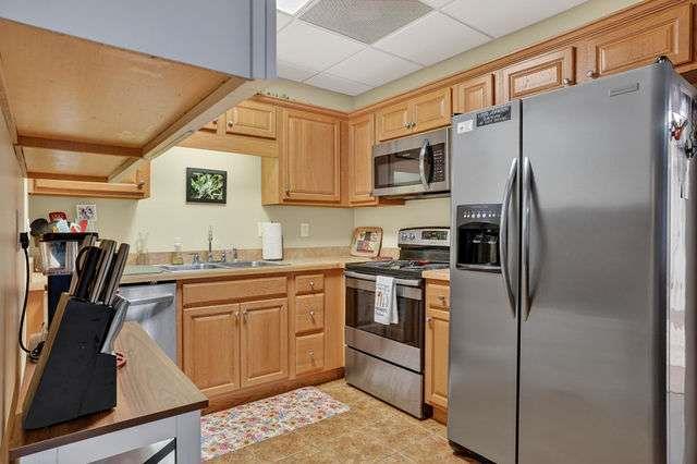 8179 Pineview Court Villa Rica, GA 30180 - Photo 25 of 41 a kitchen with stainless steel appliances granite countertop a refrigerator a stove and a sink