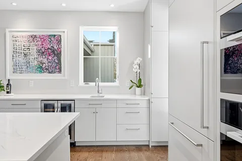 a kitchen with cabinets appliances and a window