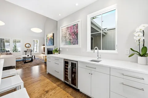 a spacious bathroom with a double vanity sink a mirror a and a window