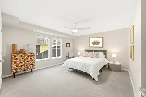 a spacious bedroom with a bed and a large window