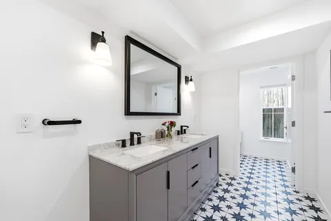 a bathroom with a double vanity sink mirror and double