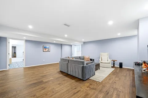 a living room with hard wood flooring and furniture