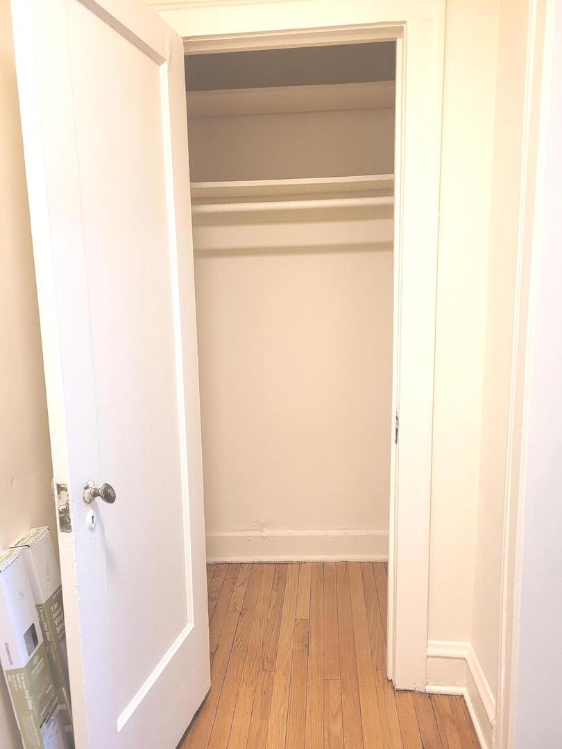 2336 East 68th Street, Unit 2 Chicago, IL 60649 - Photo 2 of 17 a view of a room with wooden floor