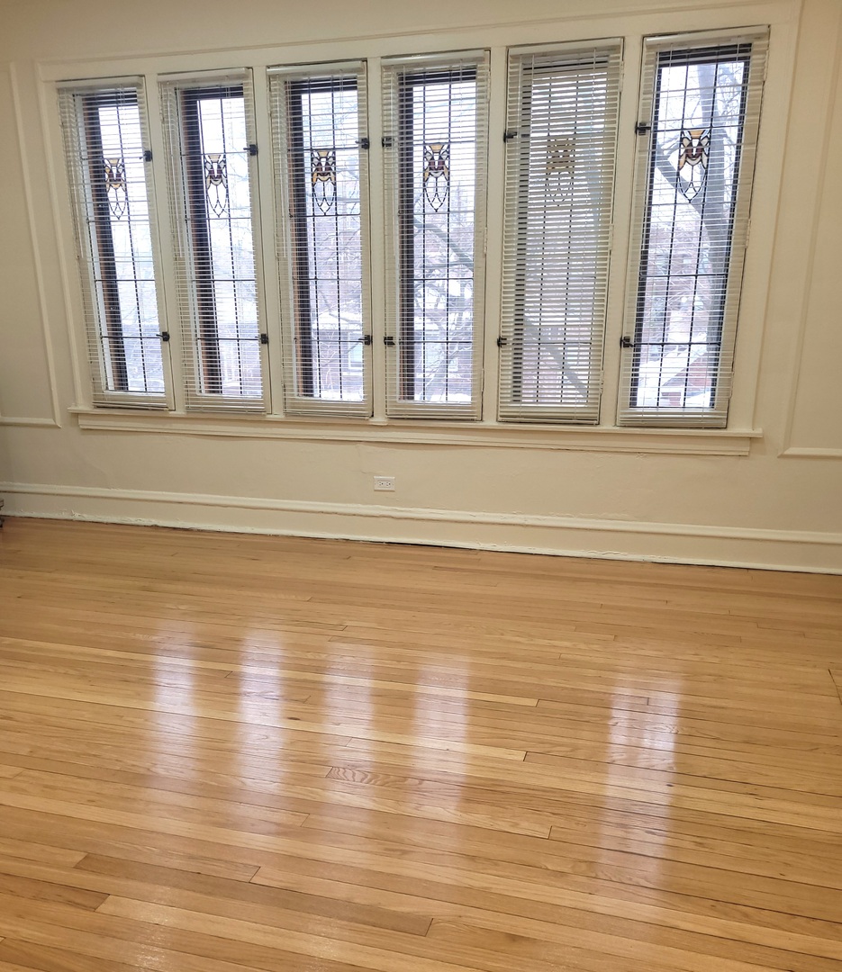 2336 East 68th Street, Unit 2 Chicago, IL 60649 - Photo 4 of 17 a view of empty room with wooden floor and fan